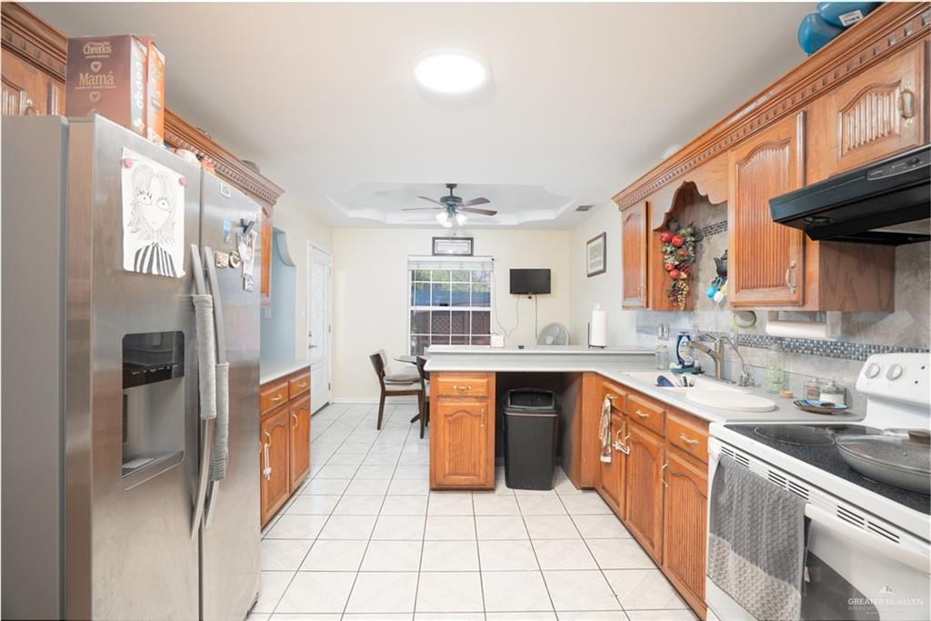 3006 Gabriel Street Mission, TX 78574 - Photo 27 of 34 a large kitchen with stainless steel appliances granite countertop a sink and cabinets