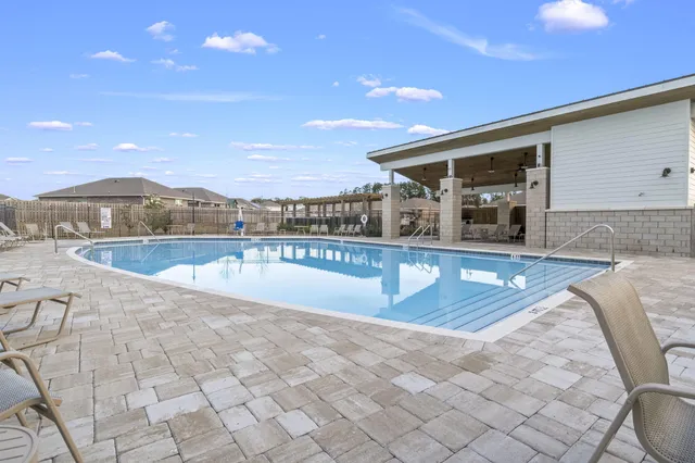 a view of a swimming pool with an outdoor seating