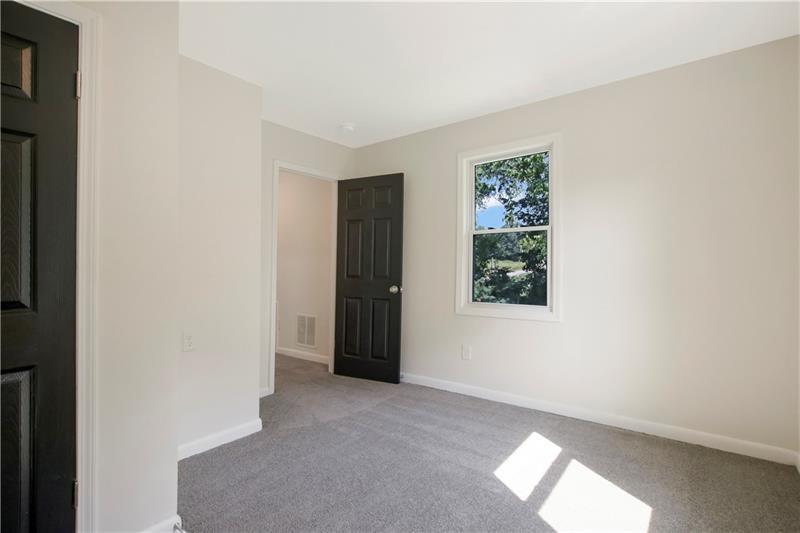 551 Valley Hill Road Southeast, Unit A Riverdale, GA 30274 - Photo 18 of 42 an empty room with windows