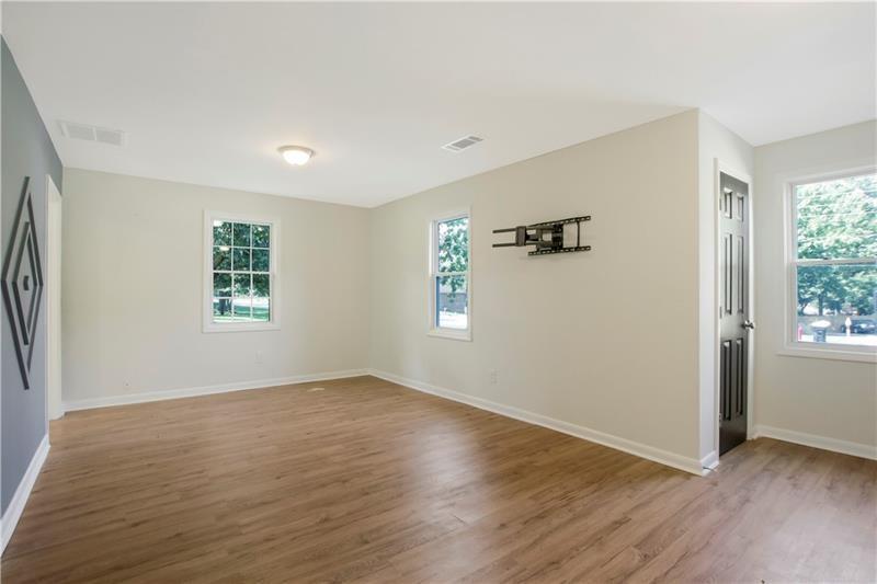 551 Valley Hill Road Southeast, Unit A Riverdale, GA 30274 - Photo 21 of 42 an empty room with wooden floor and windows