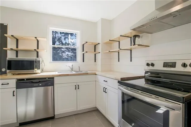 a kitchen with cabinets appliances and a window