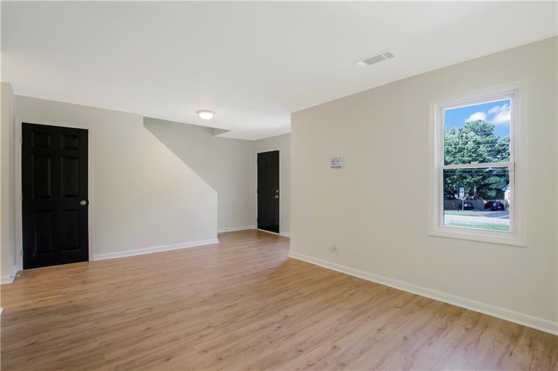 551 Valley Hill Road Southeast, Unit A Riverdale, GA 30274 - Photo 3 of 42 a view of an empty room with wooden floor and a window