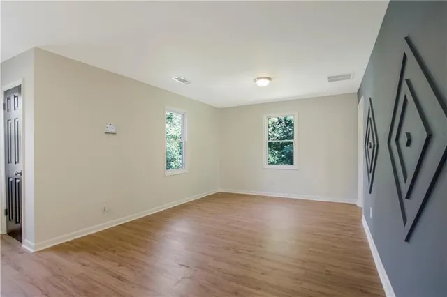 wooden floor in an empty room with a window