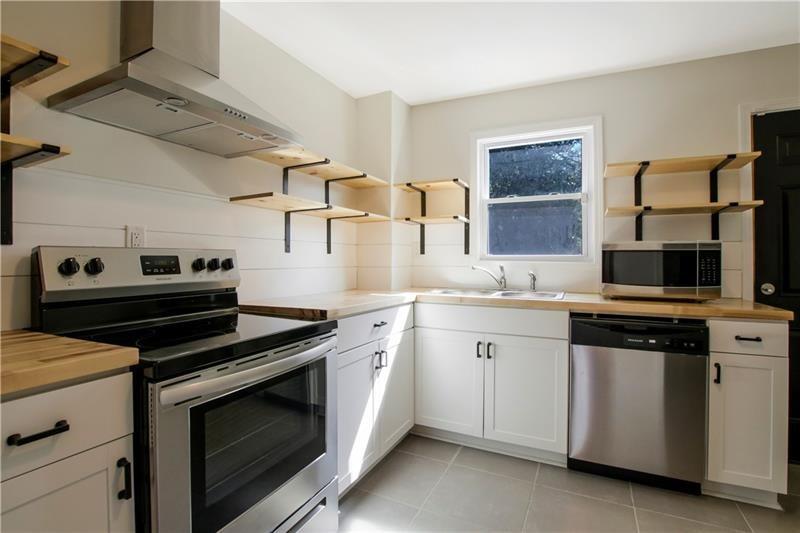 551 Valley Hill Road Southeast, Unit A Riverdale, GA 30274 - Photo 8 of 42 a kitchen with cabinets stove and sink