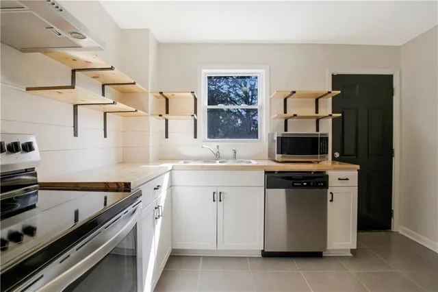 a kitchen with cabinets and appliances