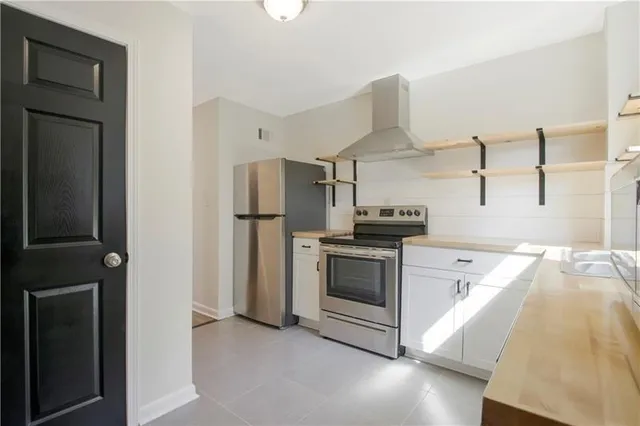 a kitchen with a refrigerator and a stove