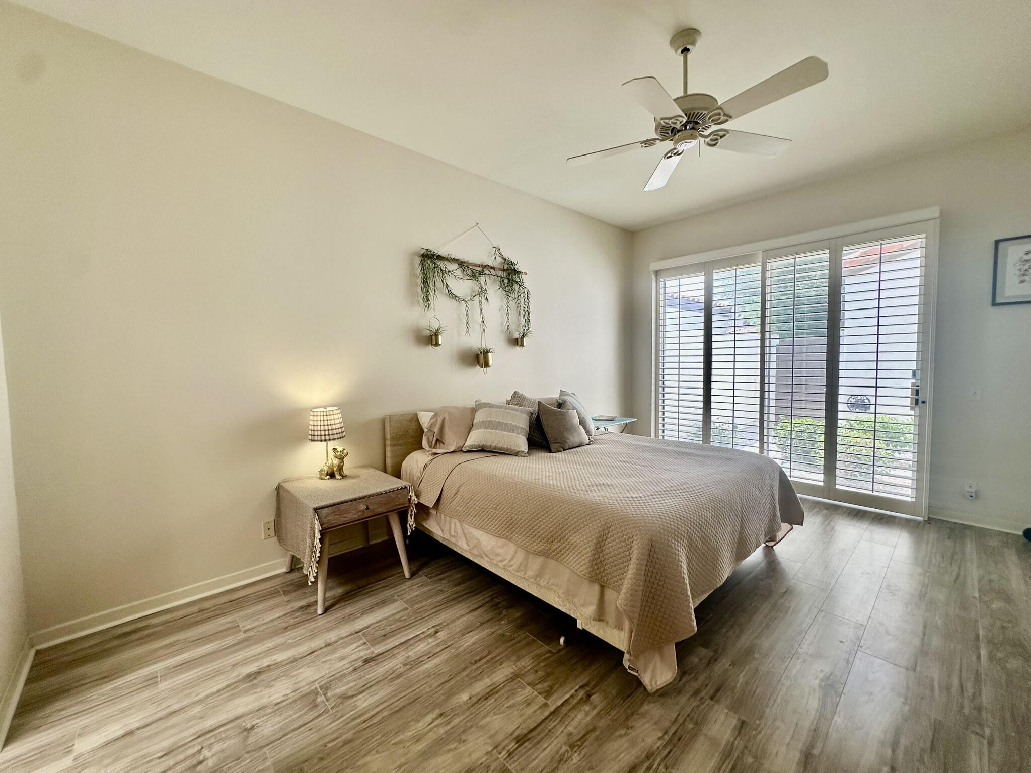 57600 Interlachen La Quinta, CA 92253 - Photo 12 of 33 a bedroom with a bed and large windows