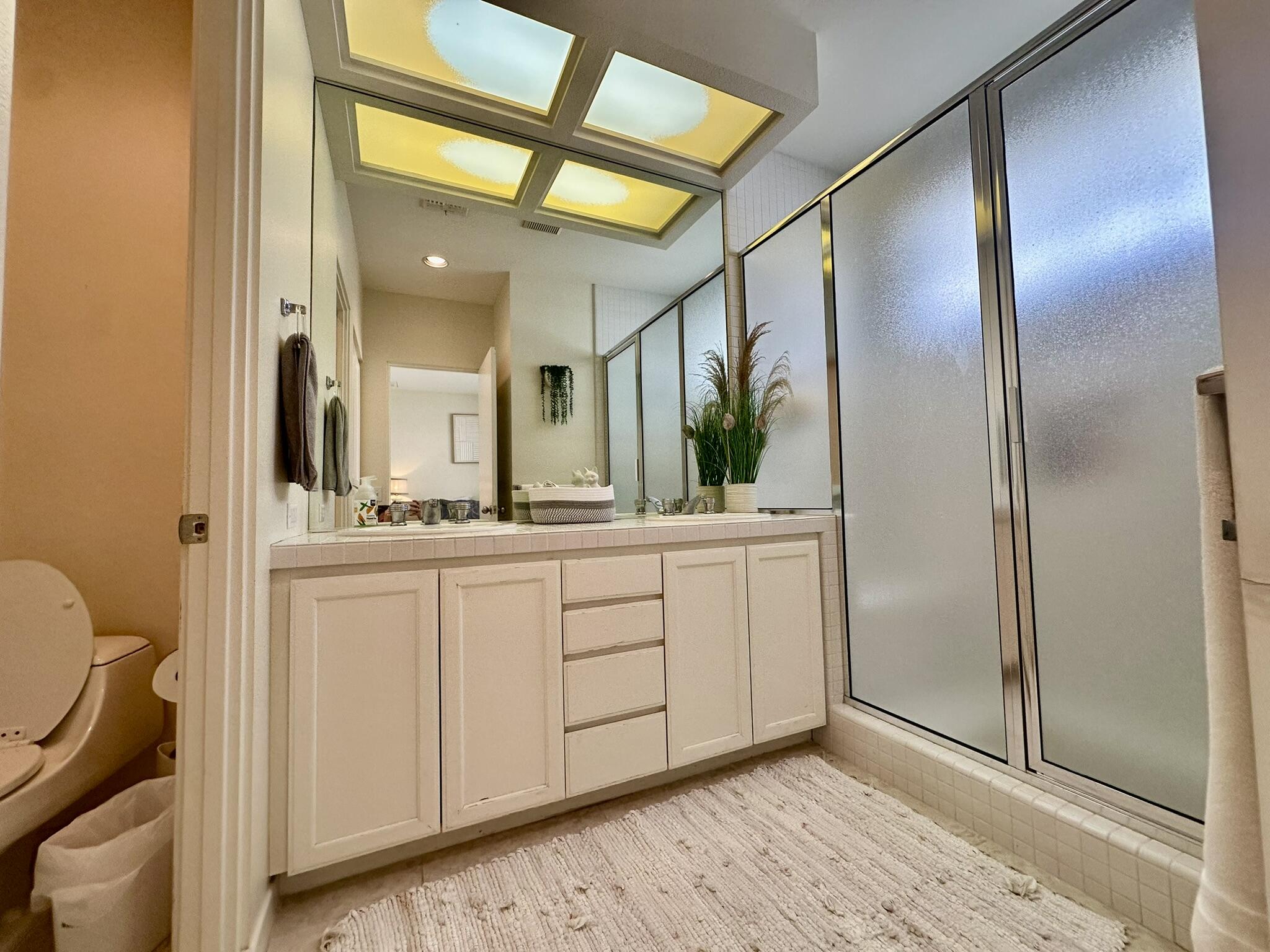 57600 Interlachen La Quinta, CA 92253 - Photo 17 of 33 a bathroom with a double vanity sink and mirror