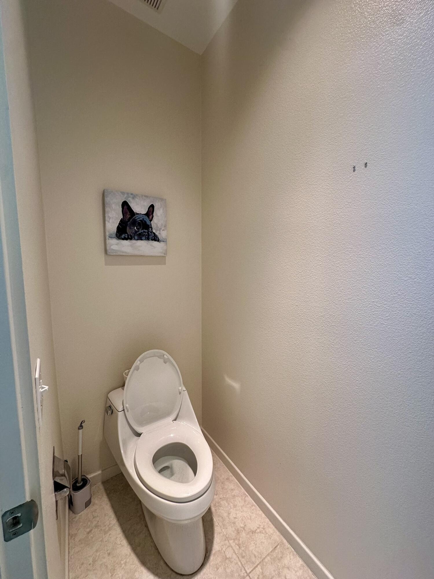 57600 Interlachen La Quinta, CA 92253 - Photo 22 of 33 a toilet sitting in a bathroom next to a wooden wall