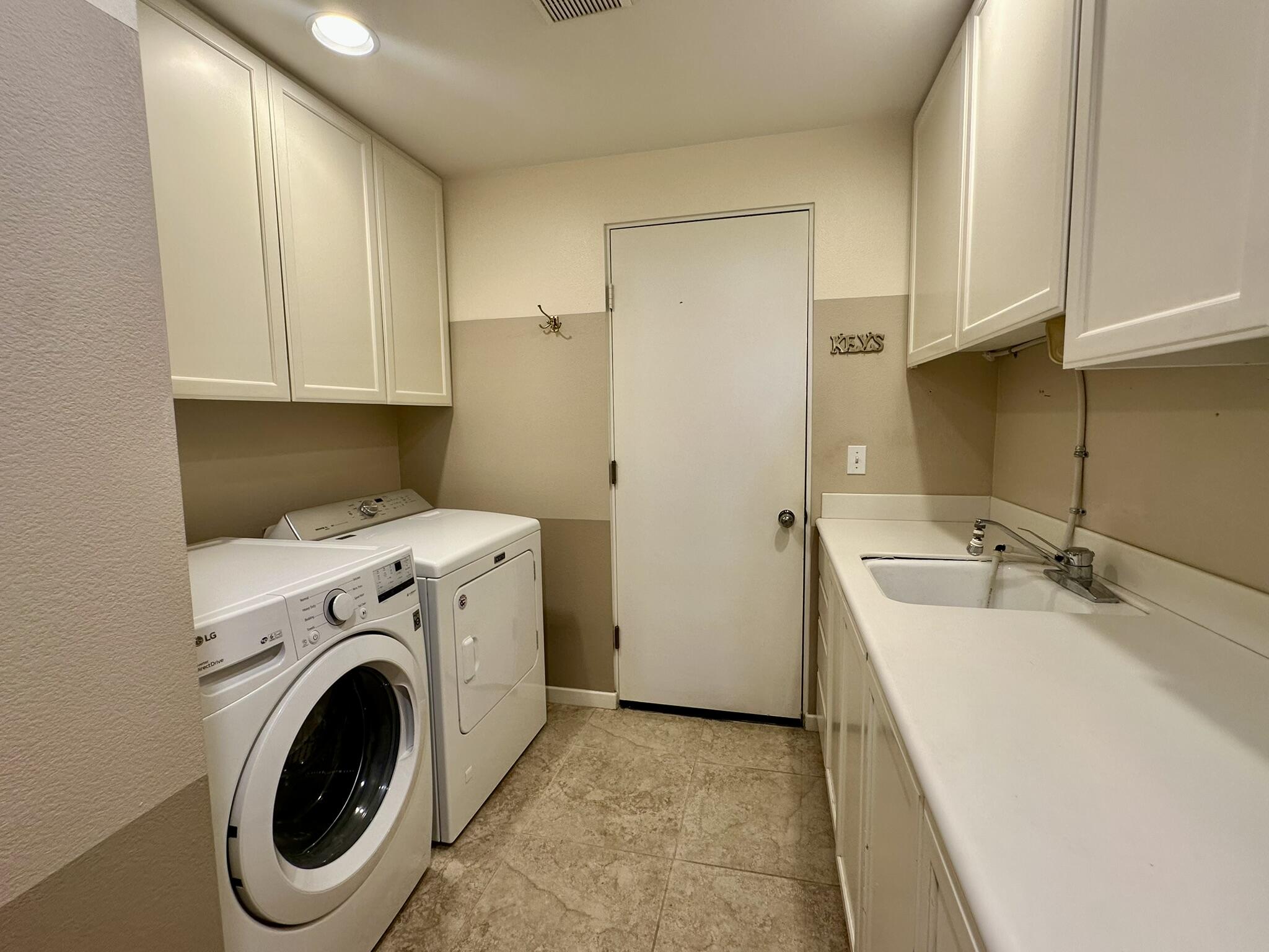 57600 Interlachen La Quinta, CA 92253 - Photo 23 of 33 a utility room with sink dryer and washer