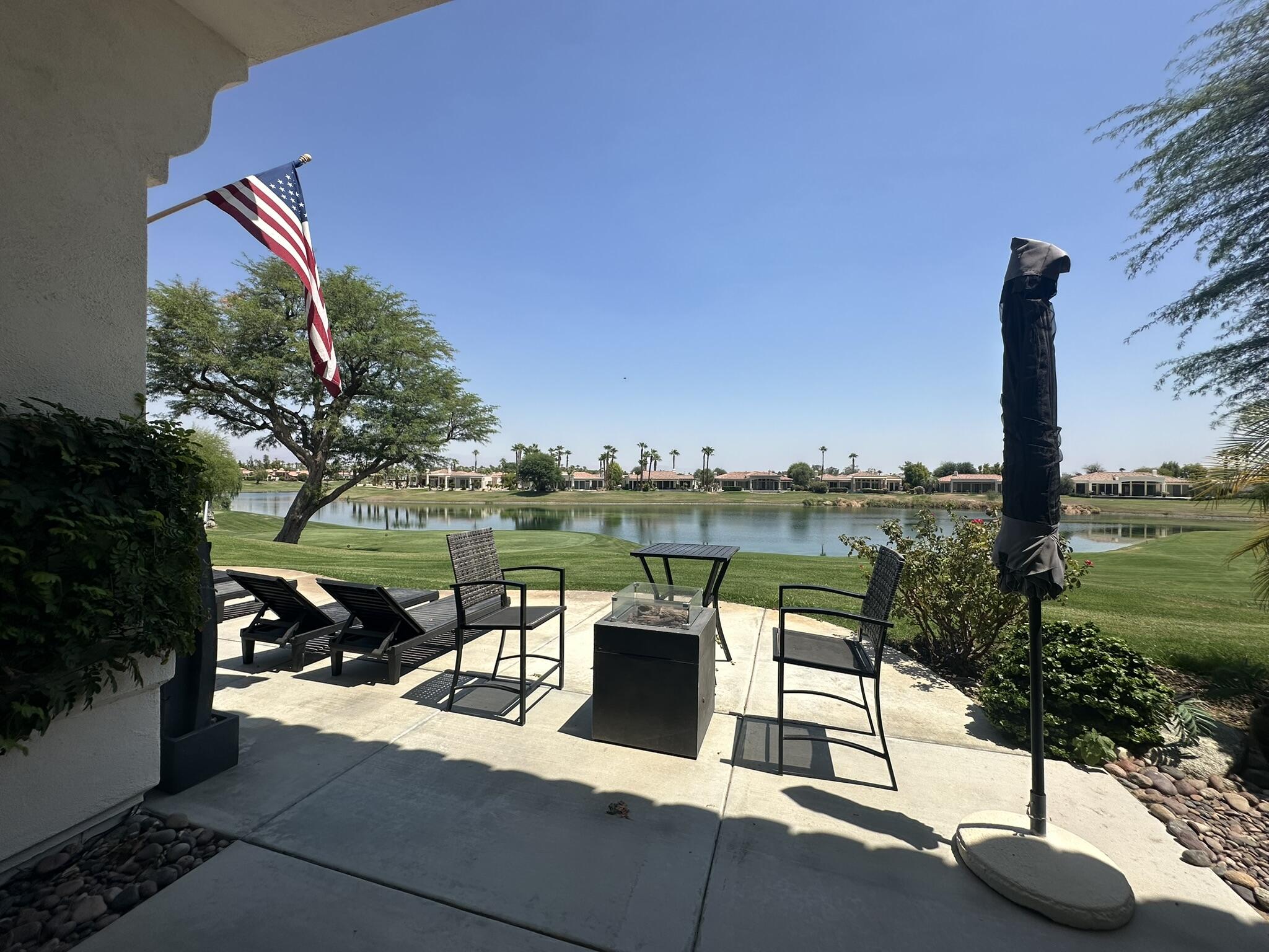 57600 Interlachen La Quinta, CA 92253 - Photo 25 of 33 a view of a lake with a table and chairs next to yard