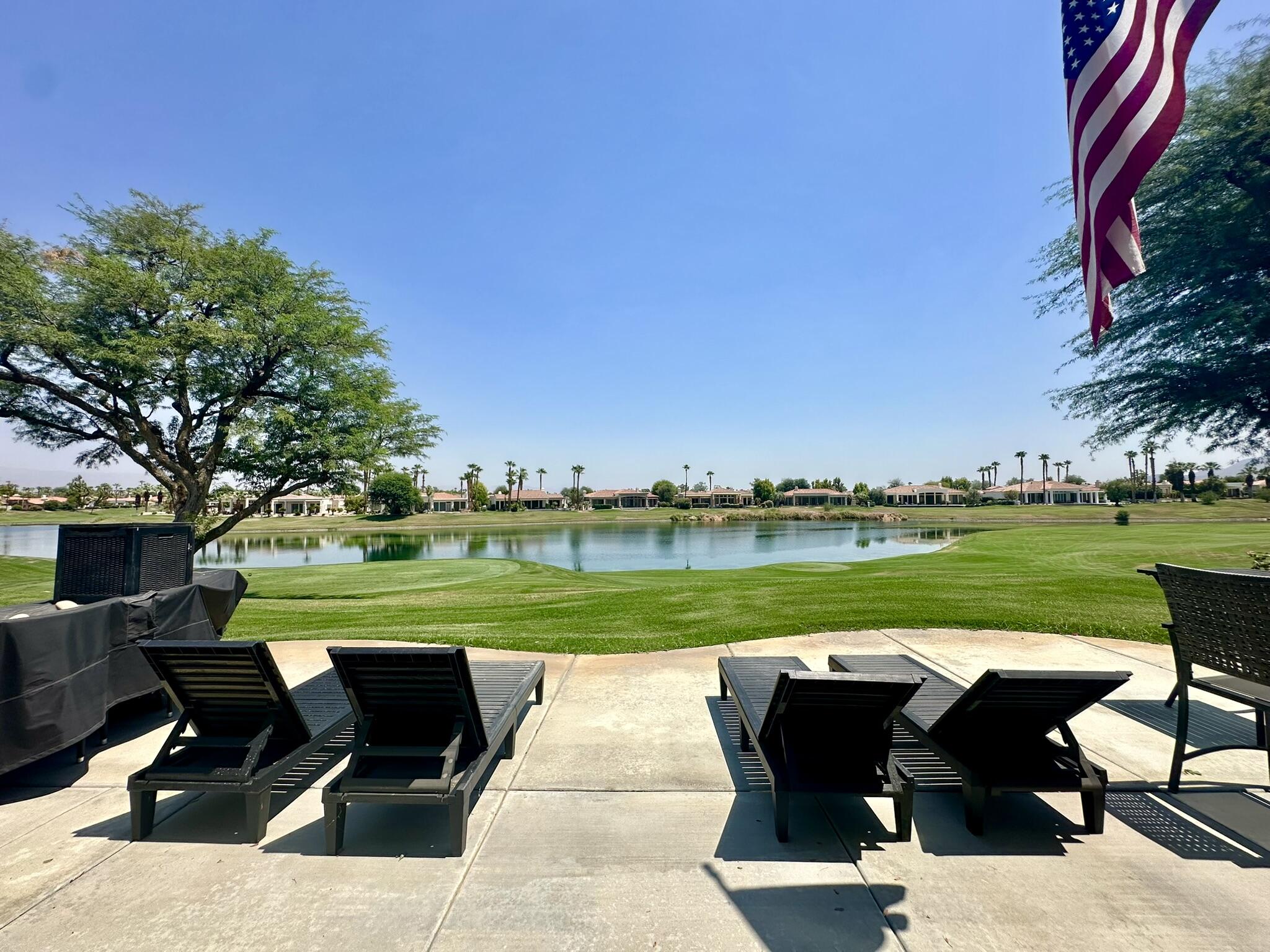 57600 Interlachen La Quinta, CA 92253 - Photo 26 of 33 a view of a swimming pool and lounge chairs in back of the house