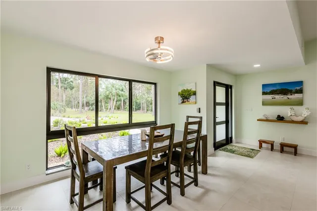 a kitchen with stainless steel appliances kitchen island granite countertop a refrigerator and a sink
