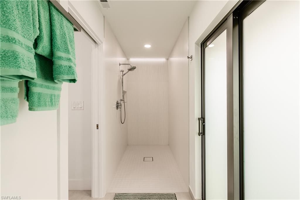 3511 17th Avenue Southwest Naples, FL 34117 - Photo 16 of 32 a bathroom with a shower and a glass door