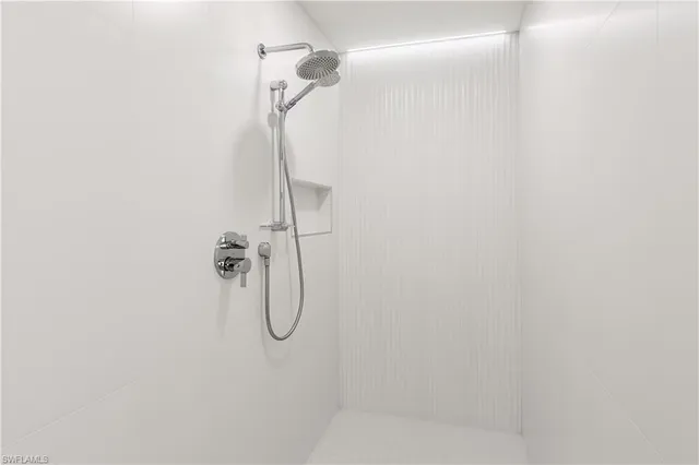 a bathroom with a shower and a glass door