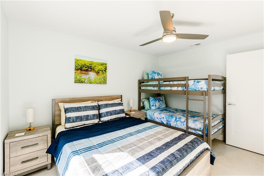 3511 17th Avenue Southwest Naples, FL 34117 - Photo 20 of 32 a bedroom with a bed and a dresser