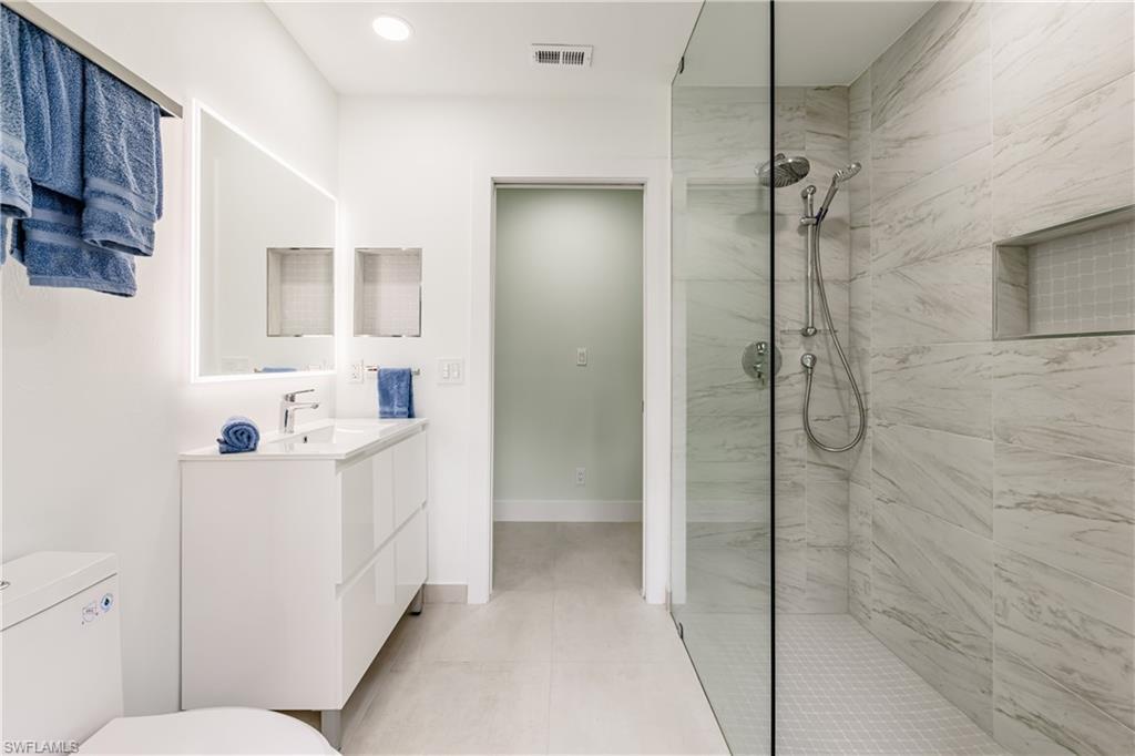 3511 17th Avenue Southwest Naples, FL 34117 - Photo 21 of 32 a bathroom with a sink a toilet and shower