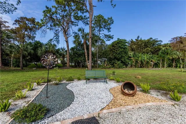 a view of outdoor space with garden and trees