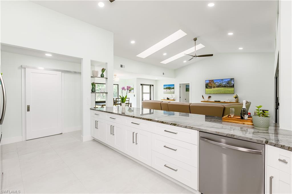 3511 17th Avenue Southwest Naples, FL 34117 - Photo 6 of 32 a kitchen with granite countertop lots of white cabinets and sink