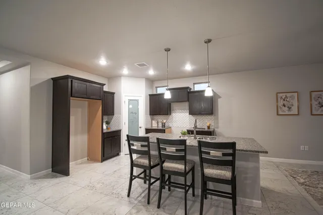 a kitchen with a table and chairs in it