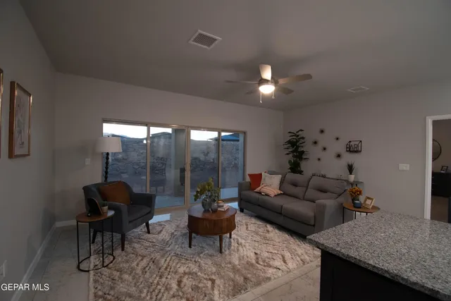 a living room with furniture and a chandelier