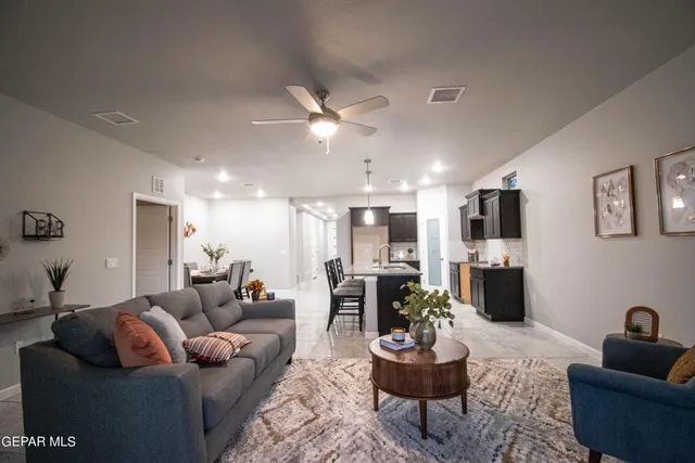 a living room with furniture and a wooden floor