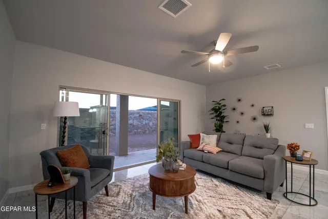 a living room with furniture and a large window