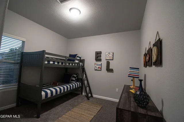 a bedroom with furniture and wooden floor