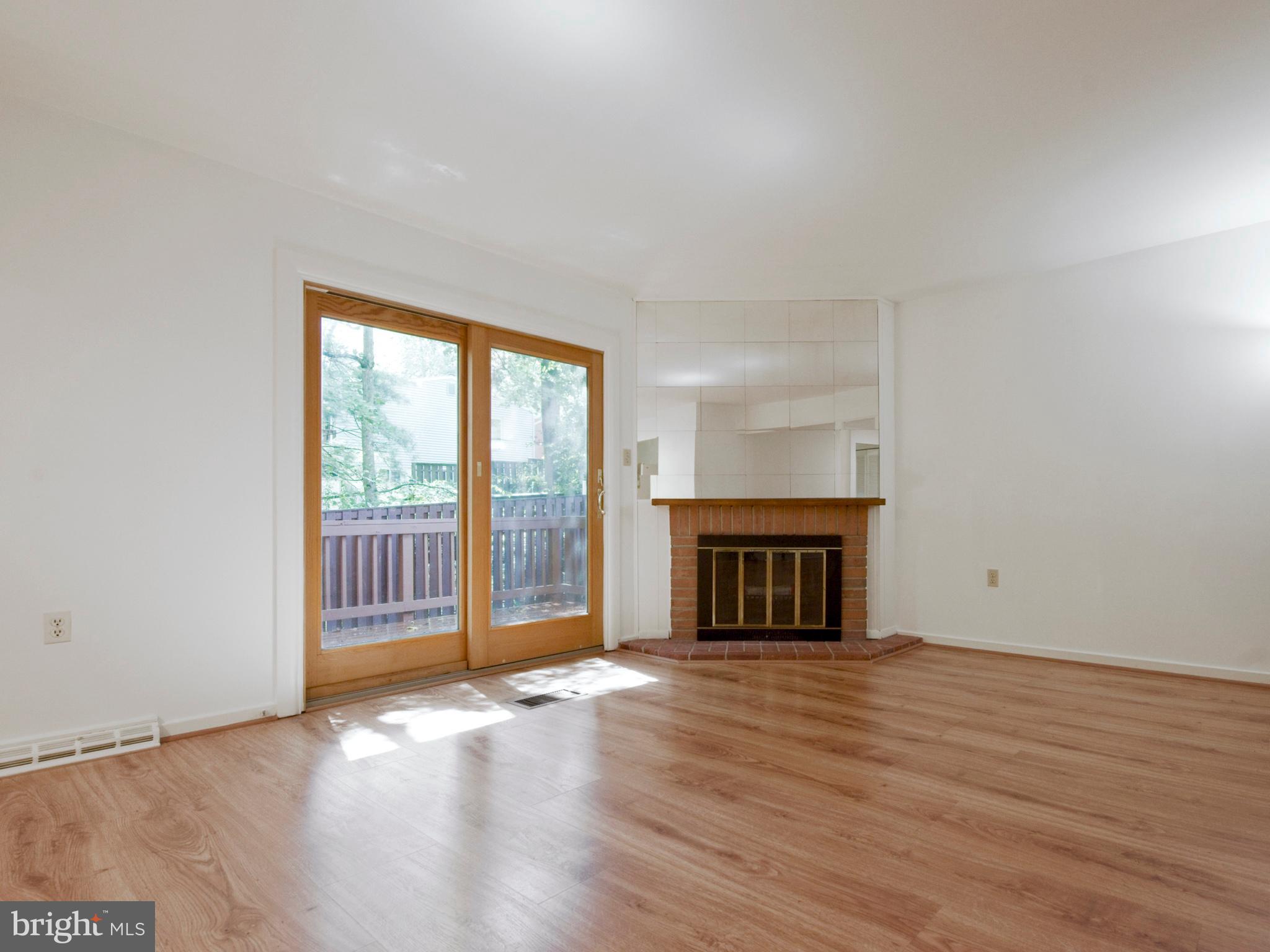 2360 Old Trail Drive Reston, VA 20191 - Photo 11 of 40 Living room, deck entrance, and wood fireplace