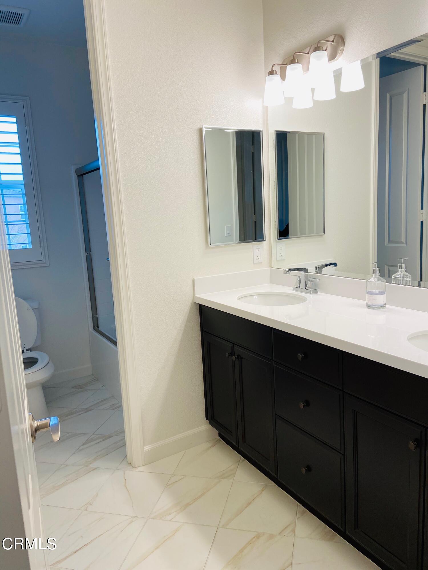 1645 Range Road Oxnard, CA 93036 - Photo 14 of 34 a bathroom with a sink vanity and a mirror