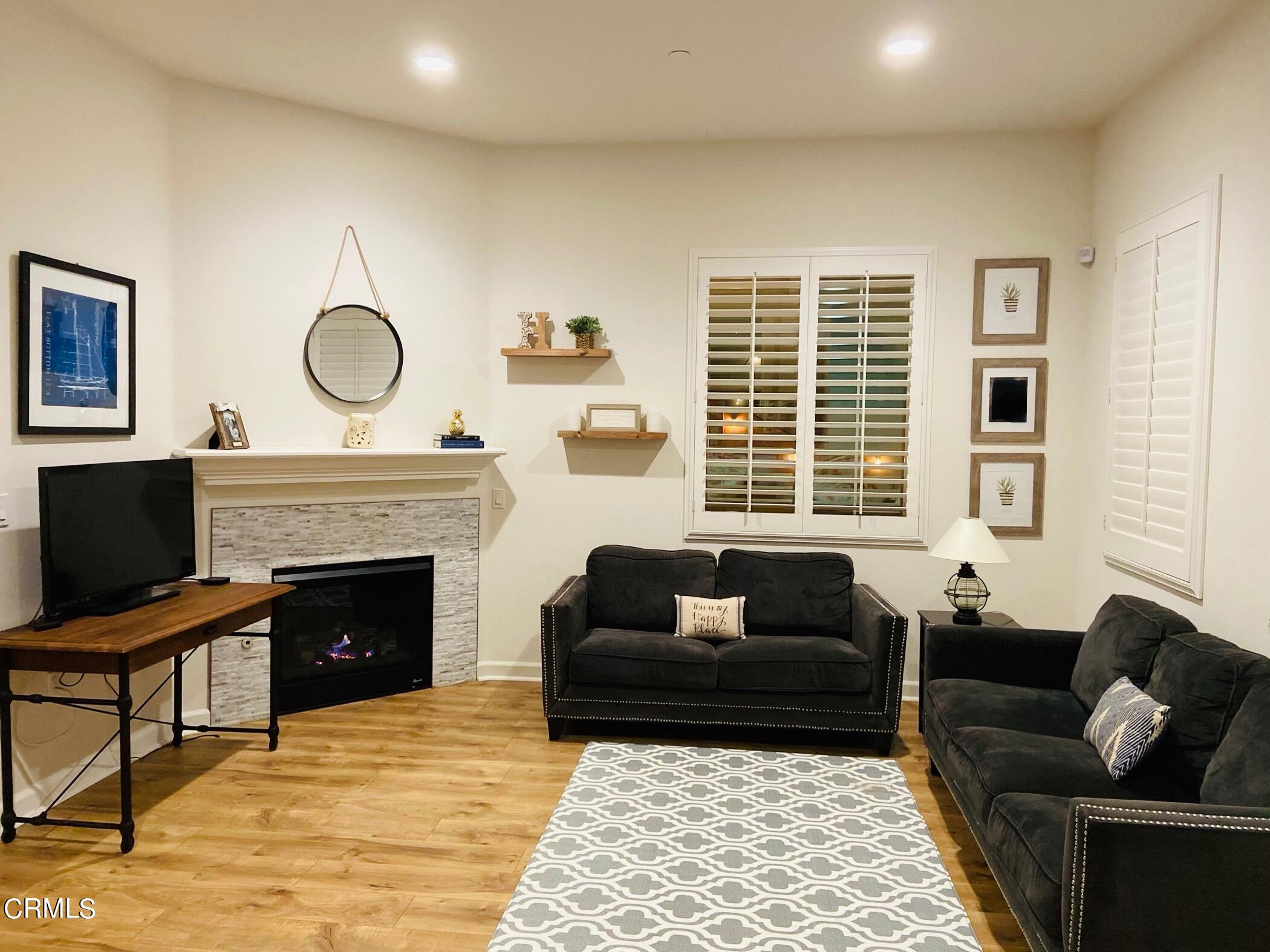 1645 Range Road Oxnard, CA 93036 - Photo 5 of 34 a living room with furniture a fireplace and wooden floor