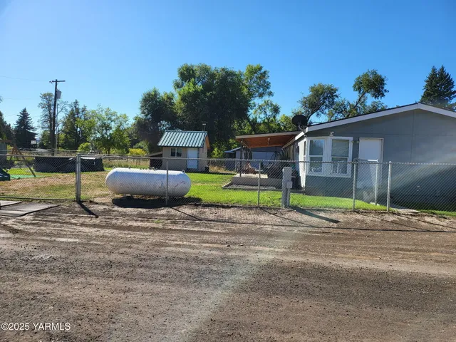 a view of backyard with swimming pool and porch