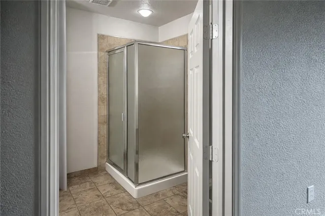 a bathroom with a glass shower door
