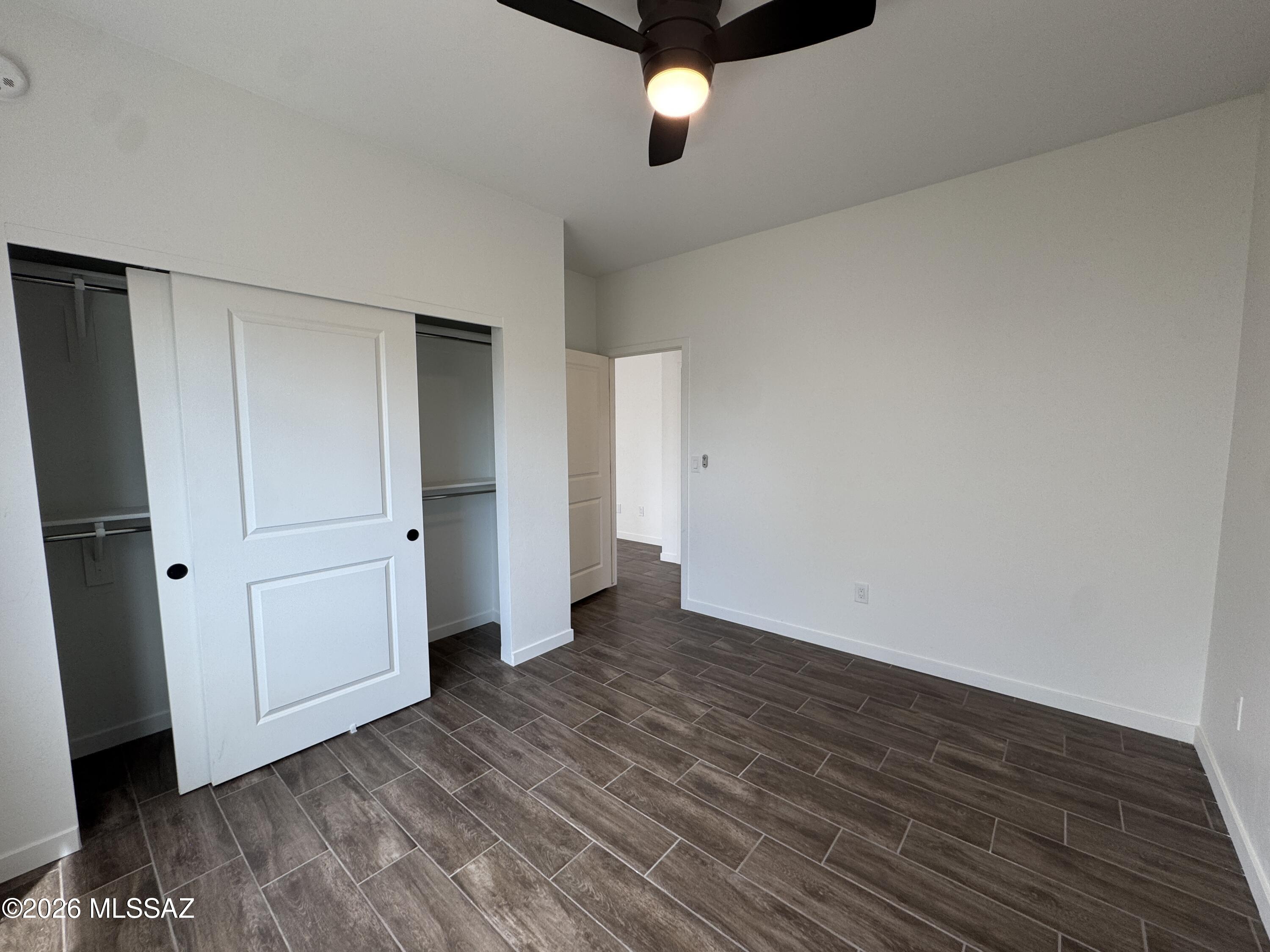 2130 North Ralph Avenue, Unit 1 Tucson, AZ 85712 - Photo 6 of 11 a view of an empty room with wooden floor