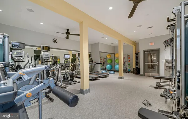 a view of a big room with wooden floor and windows