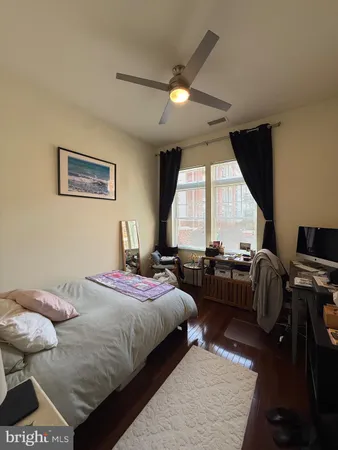 a bedroom with a bed couch and a window