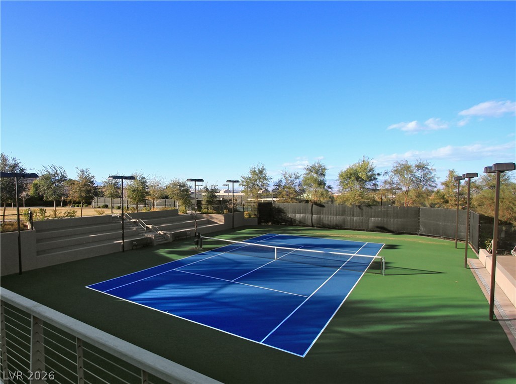 505 Overlook Rim Drive Henderson, NV 89012 - Photo 20 of 22 DragonRidge Country Club features inviting tennis courts with bleacher seating, awaiting your next match under a clear sky.