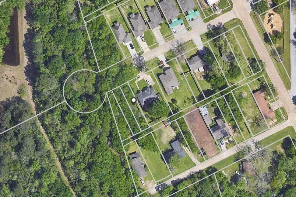 an aerial view of a residential apartment building with a yard