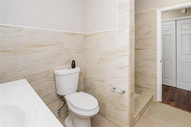 a bathroom with a toilet and a shower