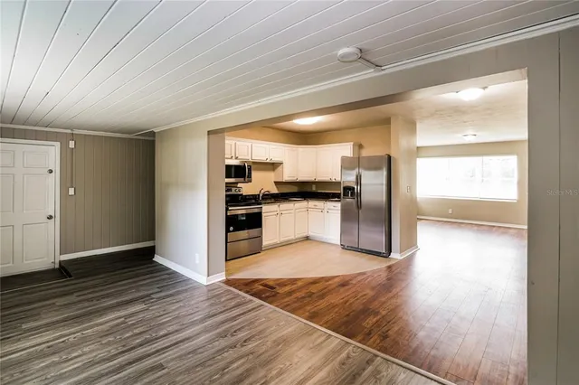 a view of kitchen view wooden floor and electronic appliances