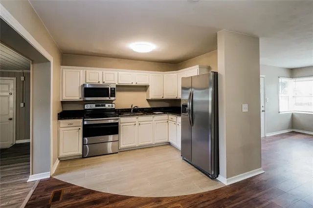 a kitchen with stainless steel appliances a refrigerator stove and microwave