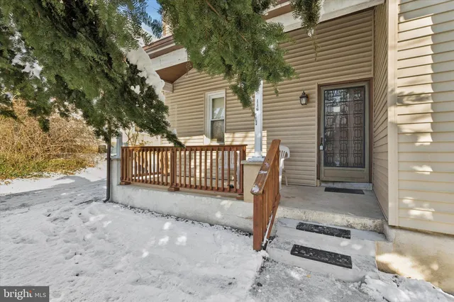 a view of a deck with a fence and a tree