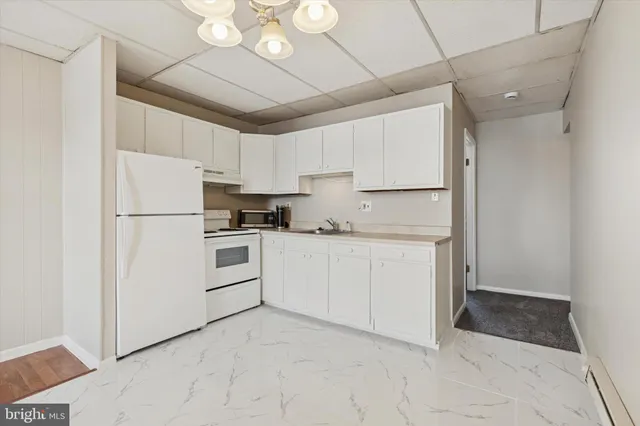 a kitchen with cabinets and stainless steel appliances