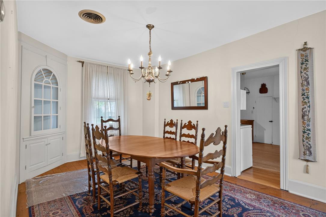 765 East Macada Road Bethlehem, PA 18017 - Photo 12 of 46 A classic chandelier illuminates the formal dining space, complete with built-in cabinetry and warm hardwood flooring.
