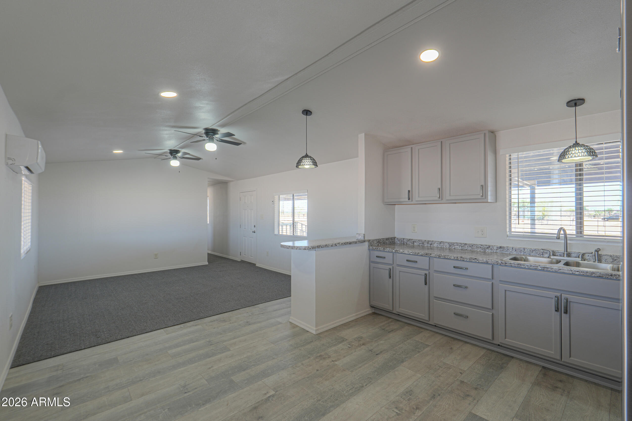 33776 West Siesta Road Stanfield, AZ 85172 - Photo 40 of 54 a view of a kitchen with a sink cabinets and wooden floor
