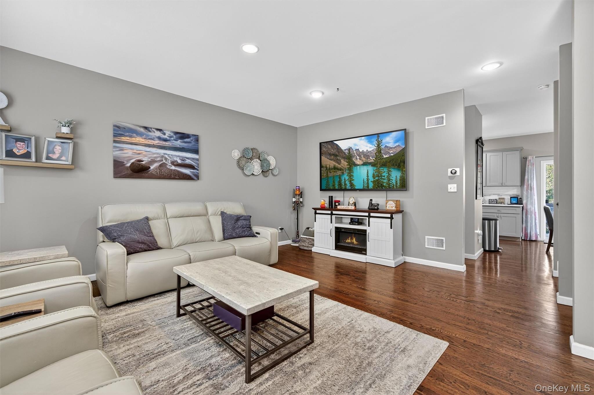 26 Peter Turner Road Monroe, NY 10950 - Photo 12 of 47 a living room with furniture a flat screen tv and a fireplace
