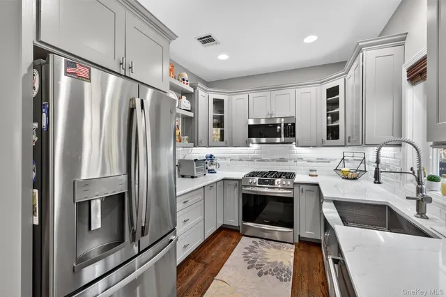 a kitchen with a stove a sink and a window