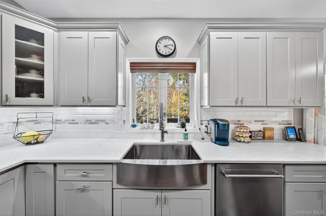 a kitchen with granite countertop a stove a sink and a refrigerator