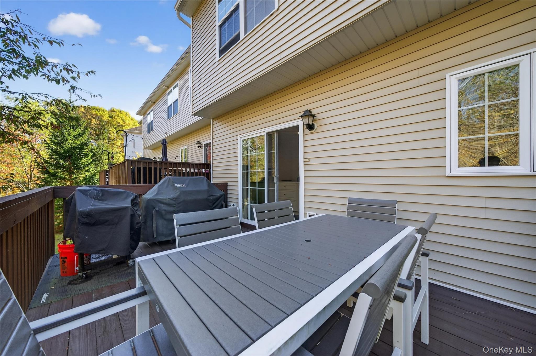 26 Peter Turner Road Monroe, NY 10950 - Photo 42 of 47 a view of a patio with table and chairs with wooden floor and fence