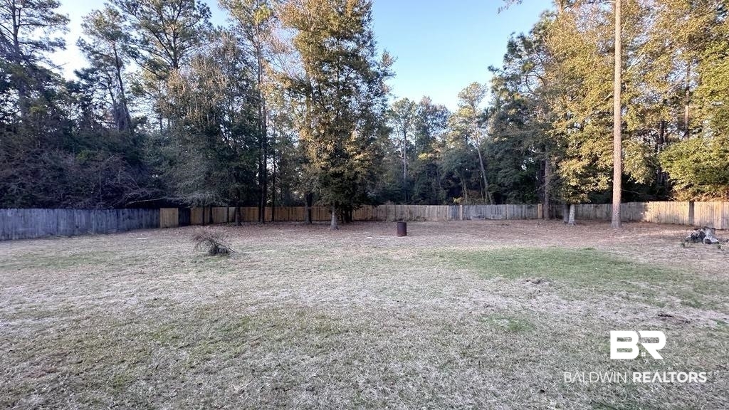 23289 McPhillips Road Loxley, AL 36551 - Photo 16 of 19 Expansive grassy yard with mature trees and a perimeter fence
